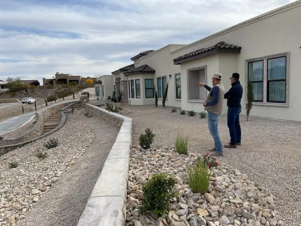 Jesus Palma, owner of Black Rock Development is looking at construction with workers.